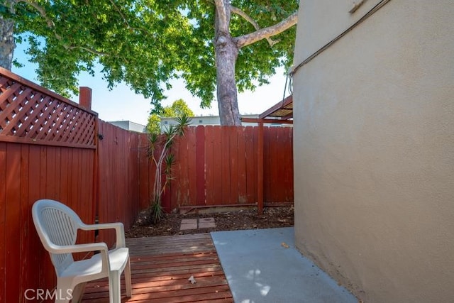 view of patio with a deck and a fenced backyard