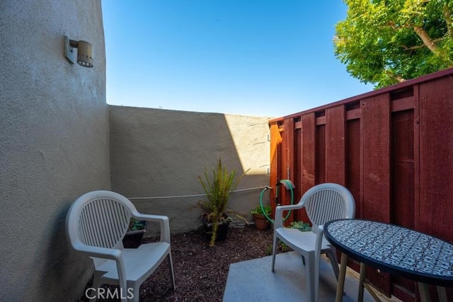 view of patio featuring fence
