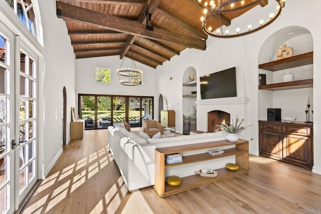 17182 Camino Acampo, Rancho Santa Fe, CA 92067 - living room featuring a warm lit fireplace, an inviting chandelier, and wood ceiling