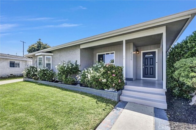 ranch-style home featuring board and batten siding and a front lawn