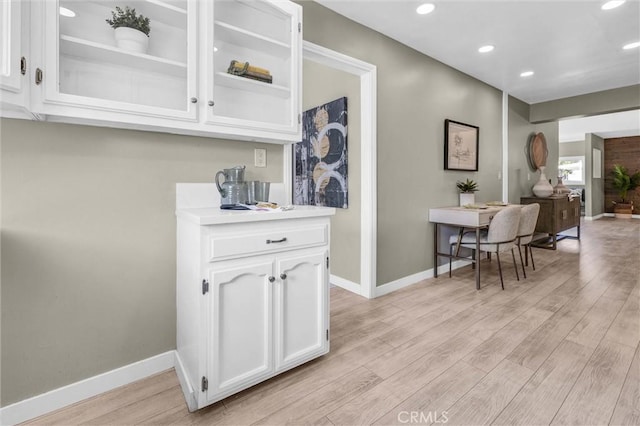 bar with recessed lighting, baseboards, and light wood-style floors