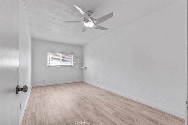 unfurnished room with baseboards, ceiling fan, and light wood-style flooring