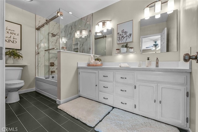 bathroom with shower / bath combination with glass door, ceiling fan, tile patterned flooring, vanity, and toilet