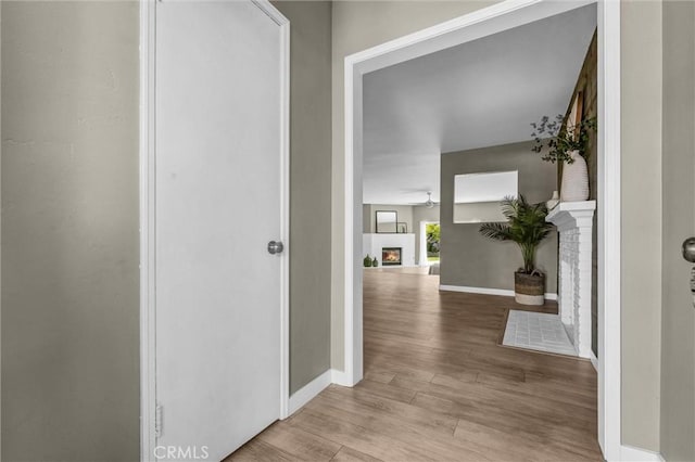 hall featuring baseboards and wood finished floors