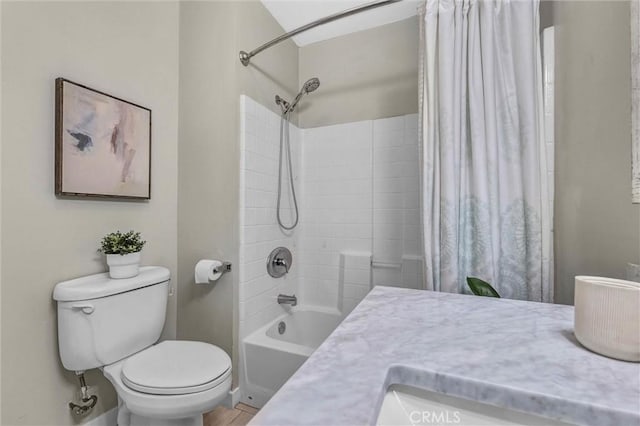 bathroom with a sink, toilet, and shower / bath combination with curtain