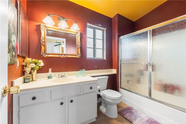 bathroom featuring shower / bath combination with glass door, toilet, tile patterned flooring, and vanity
