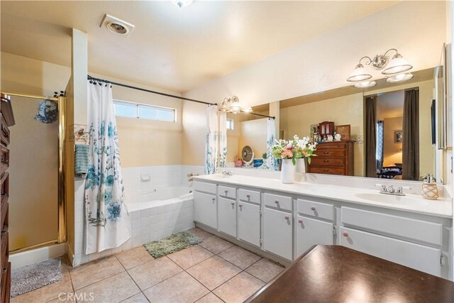 full bathroom with a relaxing tiled tub, a sink, double vanity, tile patterned floors, and a shower stall