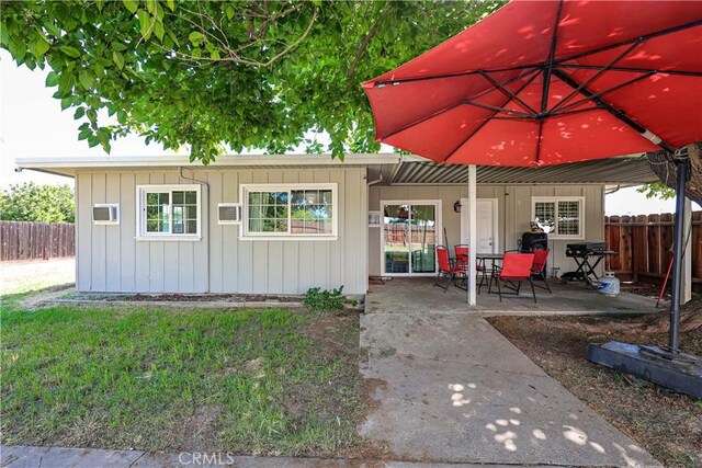 exterior space with a patio, fence, and a front yard