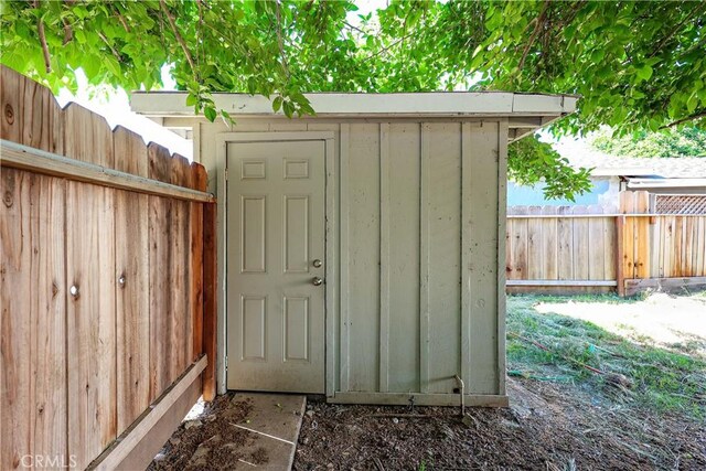 view of shed featuring fence