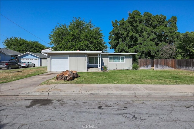 ranch-style home featuring a front lawn, fence, and concrete driveway