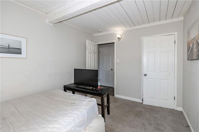 carpeted bedroom with crown molding and wooden ceiling