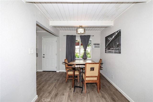 dining space with baseboards, beam ceiling, and wood finished floors