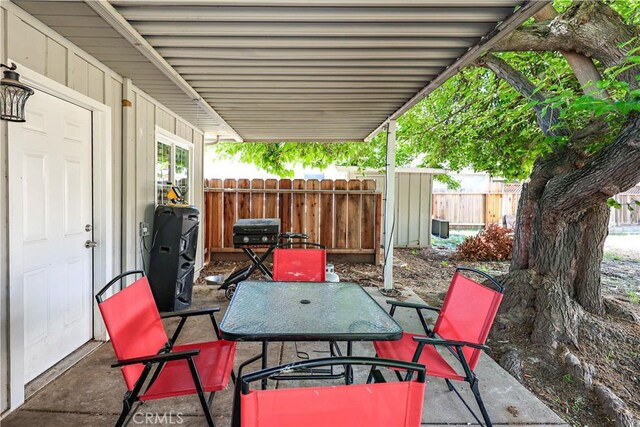 view of patio featuring fence and outdoor dining space