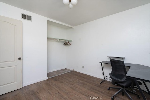 unfurnished office with wood finished floors and baseboards