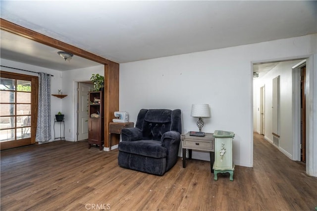 living area with wood finished floors and baseboards