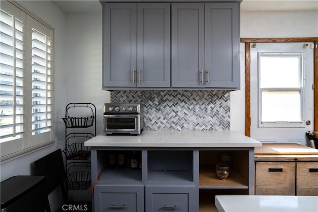 kitchen featuring gray cabinets and healthy amount of natural light