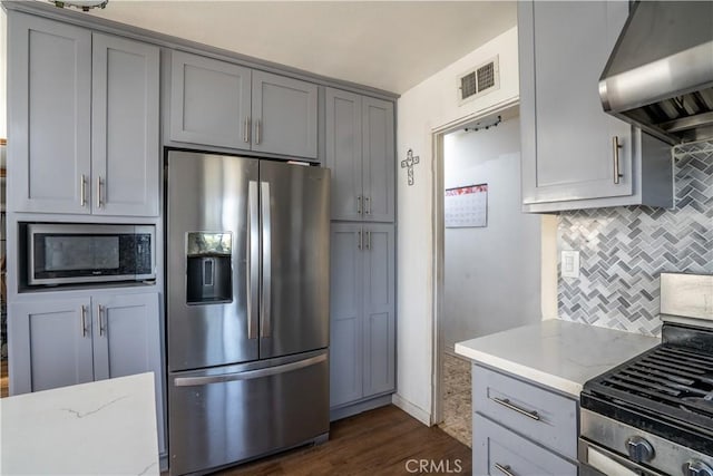 9810 Sharon Ave, Riverside, CA 92503 - kitchen featuring stainless steel appliances, gray cabinetry, island exhaust hood, decorative backsplash, and light stone counters