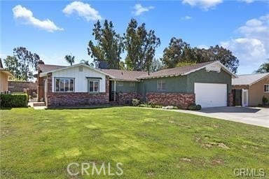 9810 Sharon Ave, Riverside, CA 92503 - single story home with an attached garage, concrete driveway, brick siding, and a front lawn
