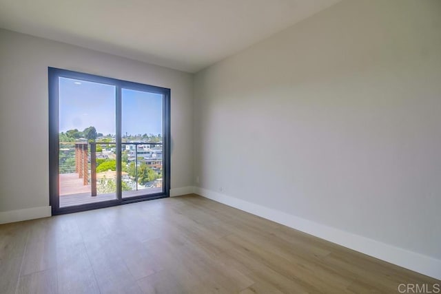 empty room with light wood-style floors and baseboards