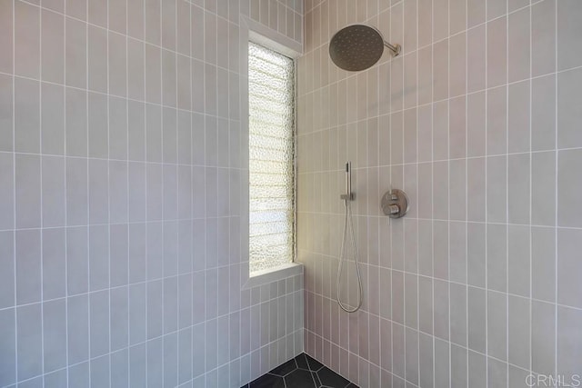 full bath with a tile shower