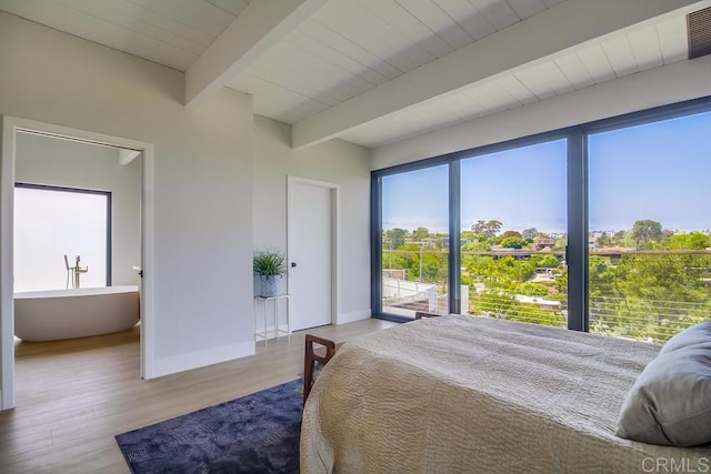 bedroom with beam ceiling, access to exterior, baseboards, wood finished floors, and visible vents