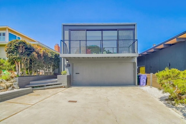 view of front facade with driveway and a balcony