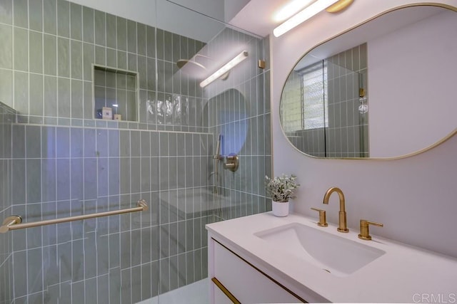 bathroom featuring a walk in shower and vanity