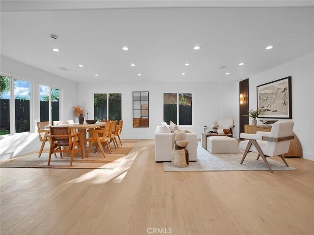 living room with recessed lighting, light wood-style floors, and baseboards