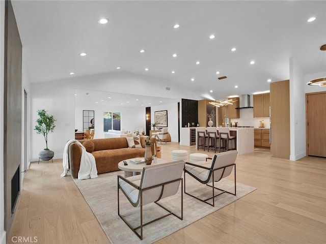 living area featuring recessed lighting, light wood-style flooring, and lofted ceiling