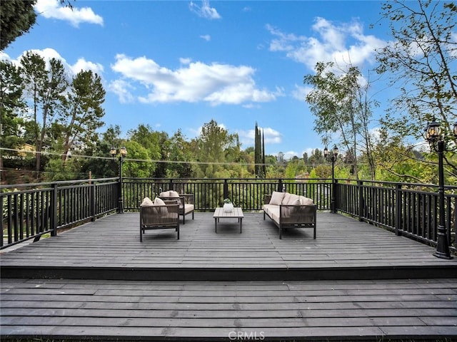 wooden deck featuring an outdoor living space