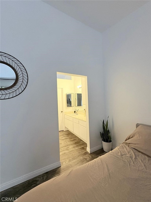 1921 Glenoaks Blvd Unit 196, San Fernando, CA 91340 - bedroom featuring baseboards, ensuite bath, a sink, a towering ceiling, and dark wood-style floors