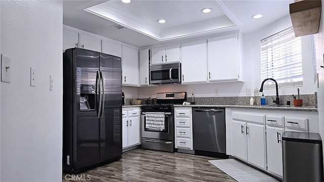1921 Glenoaks Blvd Unit 196, San Fernando, CA 91340 - kitchen with appliances with stainless steel finishes, a raised ceiling, dark wood finished floors, crown molding, and white cabinetry