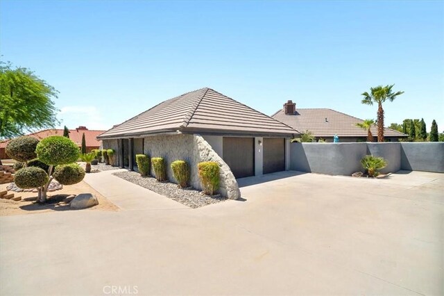 13784 Choco Rd, Apple Valley, CA 92307 - view of home's exterior with a garage, concrete driveway, and a tiled roof