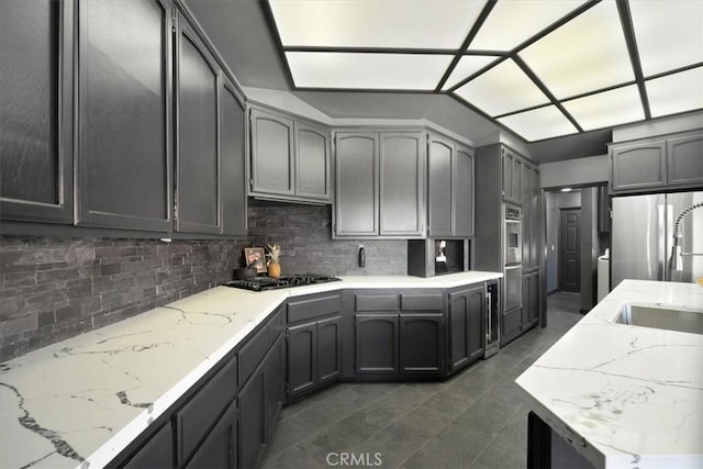 13784 Choco Rd, Apple Valley, CA 92307 - kitchen with black gas cooktop, freestanding refrigerator, tasteful backsplash, dark tile patterned floors, and light stone countertops