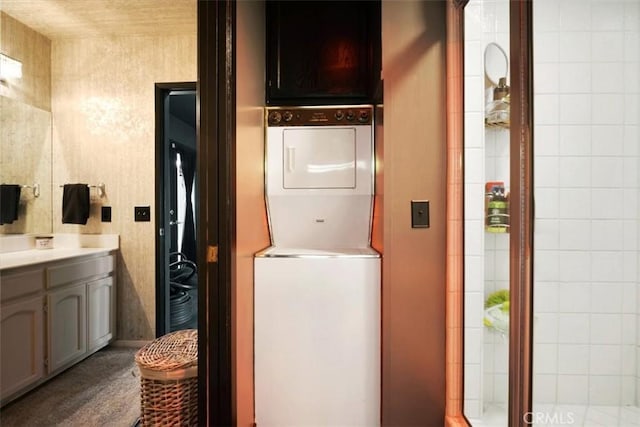 13784 Choco Rd, Apple Valley, CA 92307 - bathroom featuring stacked washing machine and dryer and vanity