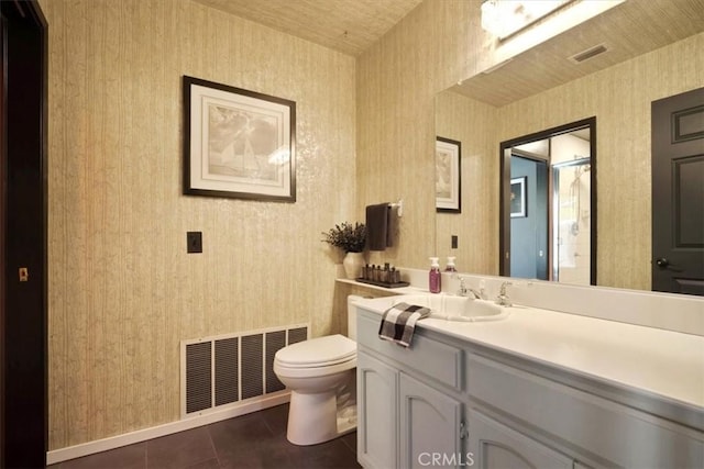 13784 Choco Rd, Apple Valley, CA 92307 - bathroom featuring toilet, tile patterned floors, wallpapered walls, vanity, and baseboards