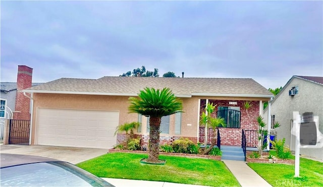 single story home featuring a garage, a front yard, stucco siding, brick siding, and driveway