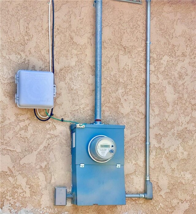 exterior details with electric meter and stucco siding