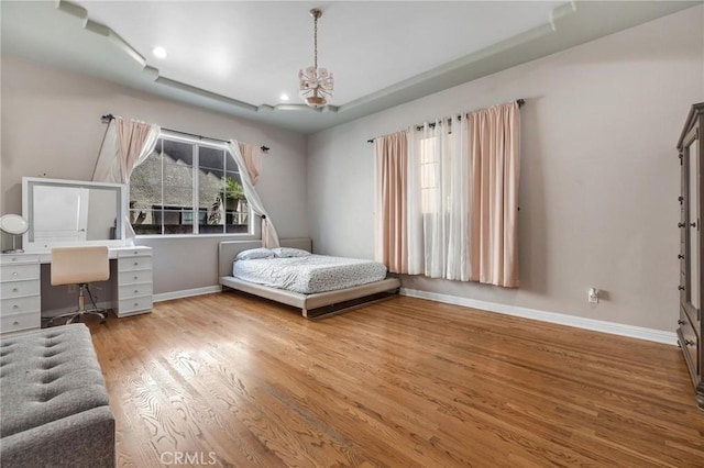 9371 Florence Ave, Downey, CA 90240 - bedroom with baseboards, recessed lighting, wood finished floors, and an inviting chandelier