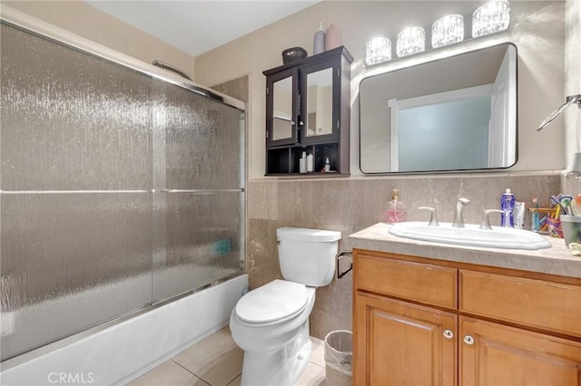 9371 Florence Ave, Downey, CA 90240 - full bath featuring tile walls, tile patterned flooring, vanity, combined bath / shower with glass door, and toilet