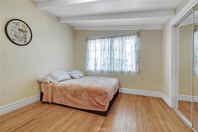 9371 Florence Ave, Downey, CA 90240 - bedroom with light wood-type flooring, baseboards, and beamed ceiling