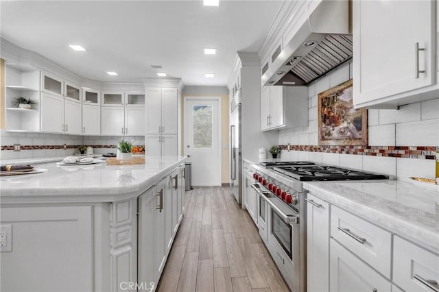 9371 Florence Ave, Downey, CA 90240 - kitchen with high end appliances, backsplash, extractor fan, and white cabinetry
