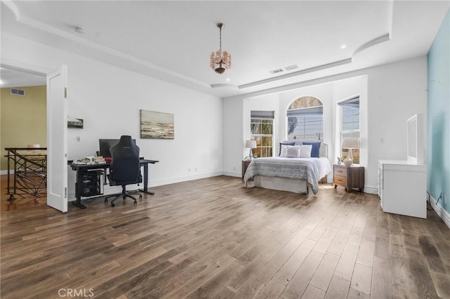 9371 Florence Ave, Downey, CA 90240 - bedroom with baseboards, a tray ceiling, wood finished floors, and visible vents