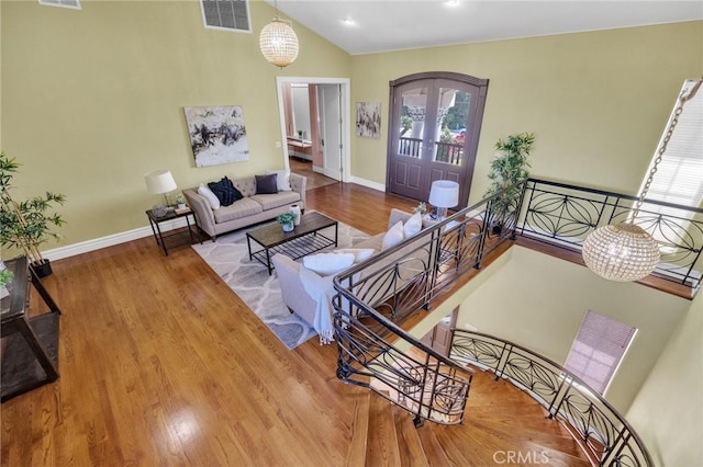 9371 Florence Ave, Downey, CA 90240 - living room with visible vents, baseboards, lofted ceiling, and wood finished floors