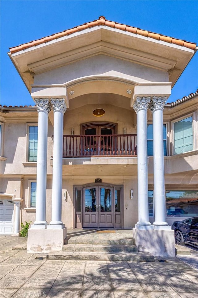 9371 Florence Ave, Downey, CA 90240 - exterior space with a porch, french doors, stucco siding, and a balcony