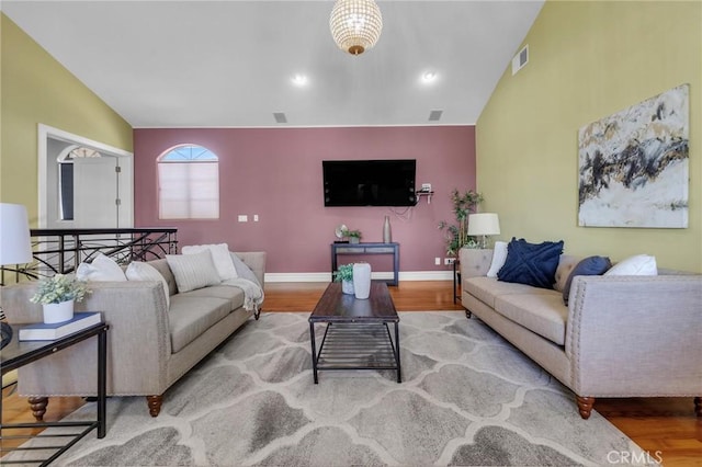 9371 Florence Ave, Downey, CA 90240 - living area featuring baseboards, vaulted ceiling, wood finished floors, and visible vents