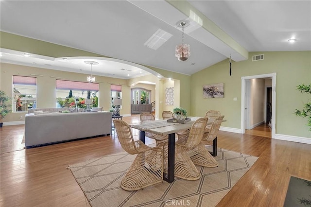 9371 Florence Ave, Downey, CA 90240 - dining space featuring visible vents, baseboards, vaulted ceiling with beams, a chandelier, and arched walkways