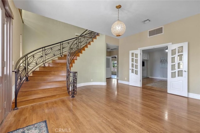 9371 Florence Ave, Downey, CA 90240 - interior space with visible vents, light wood-style floors, baseboards, and stairway