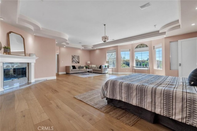 9371 Florence Ave, Downey, CA 90240 - bedroom with a fireplace, wood finished floors, baseboards, a tray ceiling, and recessed lighting