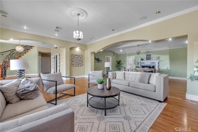 9371 Florence Ave, Downey, CA 90240 - living area featuring arched walkways, baseboards, visible vents, and wood finished floors
